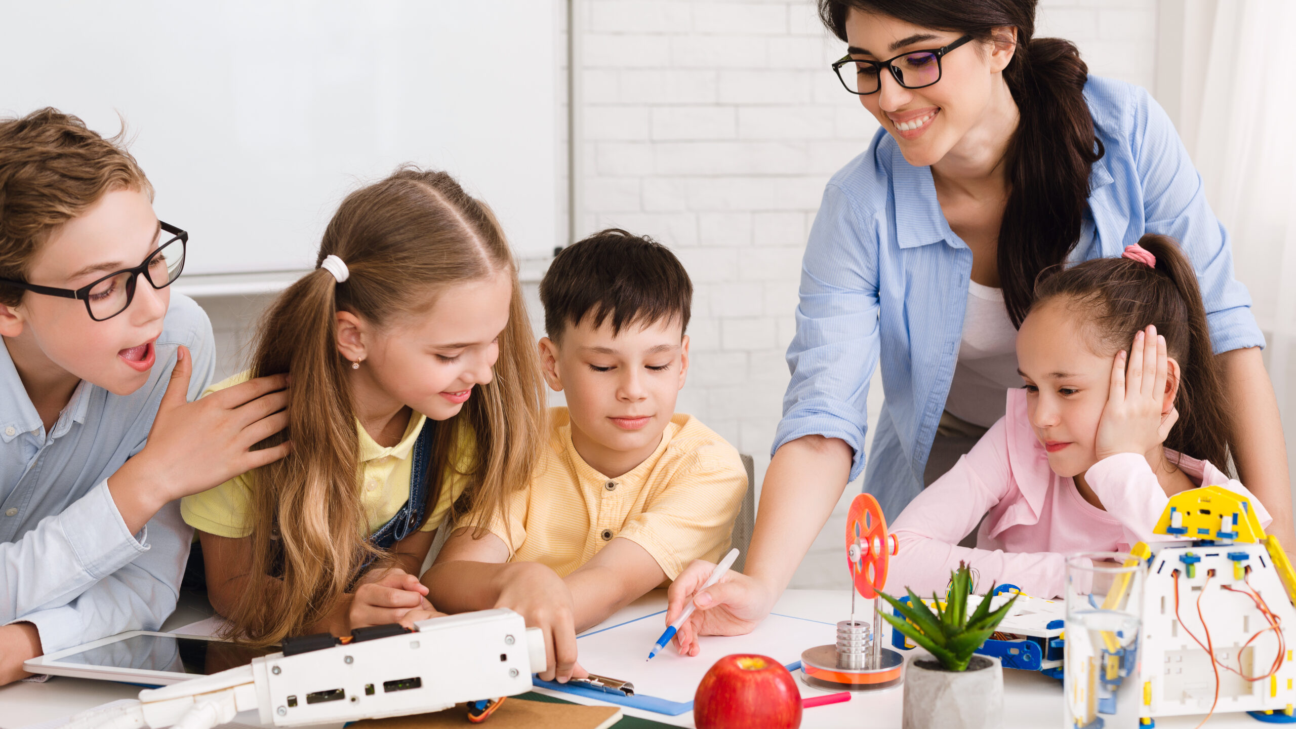 Stem education. Children studying at robotic class, making notes - Get ...